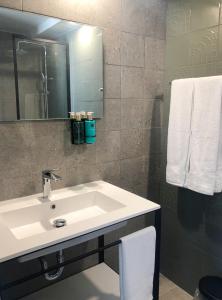 a bathroom with a sink and a mirror at Aura House Isla Verde in San Juan +108 photos