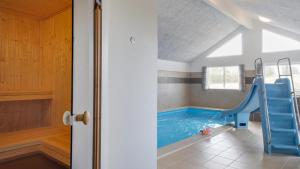 a swimming pool with a slide in a house at Villavilla 441 - Grenå Strand, Østjylland in Grenå
