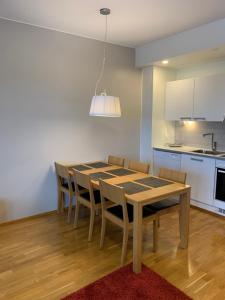 a kitchen and dining room with a table and chairs at Ruka Chalets 1304 high quality apartment in Kuusamo