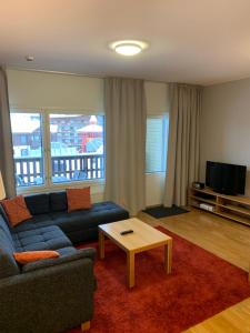 a living room with a couch and a coffee table at Ruka Chalets 1304 high quality apartment in Kuusamo