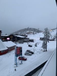 a snow covered town with cars parked in the parking lot at Ruka Chalets 1304 high quality apartment in Kuusamo