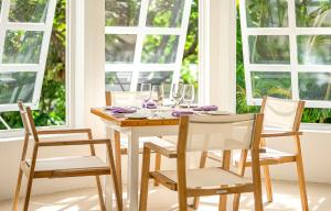 a dining room table with chairs and glasses on it at Montpelier Nevis in Nevis +41 photos