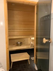 a wooden cabinet with a bowl in a kitchen at Ruka Chalets 1304 high quality apartment in Kuusamo +22 photos