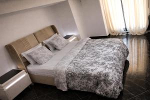 a bedroom with a bed and a couch at Nsenou Tower in Yaoundé +18 photos
