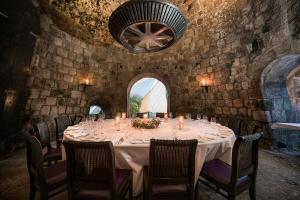 a dining room with a long table with candles at Montpelier Nevis in Nevis