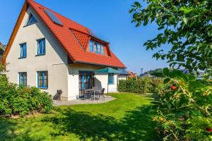 a house with an orange roof and a yard at Ferienwohnung Katharina OG in Wohlenberg +20 photos