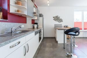 a kitchen with a sink and a chair in it at Ferienwohnung "Colonia" in Klütz