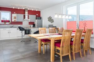 a kitchen and dining room with a wooden table and chairs at Ferienwohnung "Colonia" in Klütz