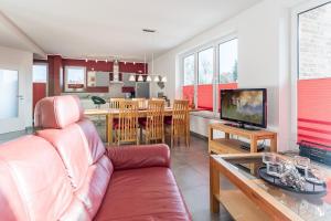 a living room with a couch and a dining room at Ferienwohnung "Colonia" in Klütz