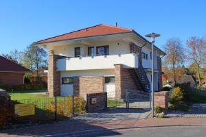 a white house with a red roof at Ferienwohnung "Colonia" in Klütz