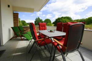 a patio with a table and chairs on a balcony at Ferienwohnung "Colonia" in Klütz +20 photos