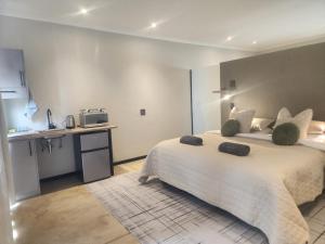 a hotel room with two beds and a kitchen at Charlen's Rest in Windhoek