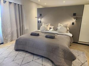 a bedroom with a large bed with white pillows at Charlen's Rest in Windhoek
