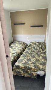 a small bedroom with two beds in it at Lambé in Pont-Aven +9 photos