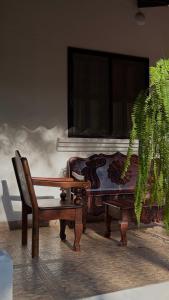 a room with a chair and a table and a plant at El Bosque Hotel in Copán Ruinas