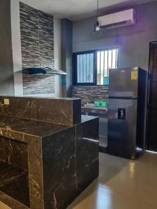 a kitchen with a stainless steel refrigerator at Casa Victoria in Valladolid