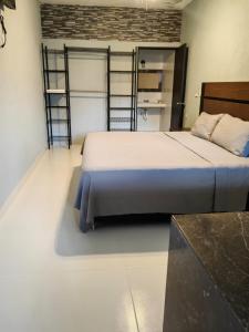 a bedroom with a bed and two metal bunk beds at Casa Victoria in Valladolid