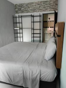 a bedroom with a bed with white sheets at Casa Victoria in Valladolid +10 photos