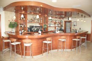 a bar in a restaurant with stools around it at Hotel Noguera El Albir in Albir
