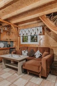 a living room with a couch and a table at Domek "Kasieńka" in Stronie Śląskie