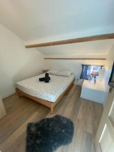 a bedroom with a bed with a teddy bear on it at spacious cottage with hot tub in Saint-Martin-dʼArdèche