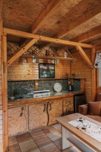 a kitchen in a wooden cabin with a table at Domek "Kasieńka" in Stronie Śląskie +98 photos