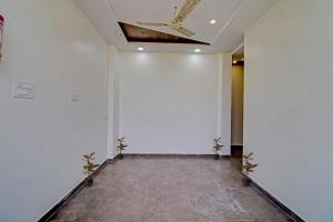 a hallway with white walls and a ceiling at Hotel O Dhurva Inn in Nagpur