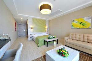 a hotel room with a bed and a couch at Sianji Well-Being Resort in Turgutreis