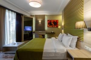 a hotel room with a large bed and a desk at Sianji Well-Being Resort in Turgutreis +165 photos