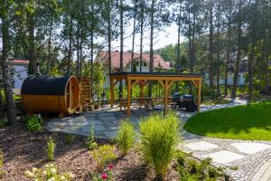 a backyard with a gazebo and a play structure at Patio Domki in Łagów +14 photos