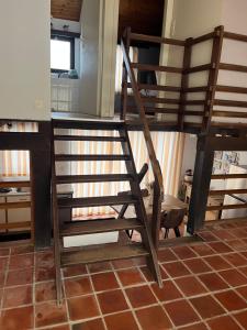 a wooden ladder sitting on top of a room at Le Ptit Nid Ivoire in Blaimont
