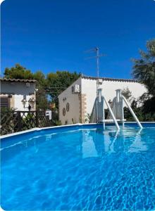 a swimming pool with a water slide in front of a house at Le Case Al Quadrato Residence in Syracuse