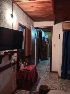 a living room with a flat screen tv on the wall at Lo de Fabi in La Coronilla
