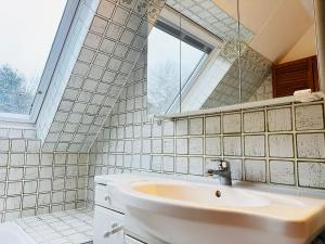 a white bathroom with a sink and a window at Zaunkönigs Nest in Böhl +7 photos