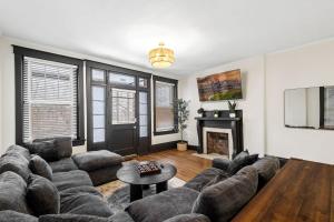 a living room with a couch and a fireplace at Cozy Home near Downtown - Close to Nulu - Sleeps 6 in Louisville
