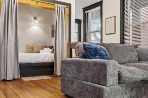 a living room with a couch and a bed at Cozy Home near Downtown - Close to Nulu - Sleeps 6 in Louisville