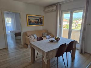 a living room with a table and a couch at Apartments Poljak in Supetarska Draga