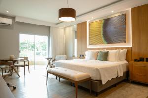 a bedroom with a bed and a table and chairs at Hotel Equinocios Executive in Barcarena +102 photos