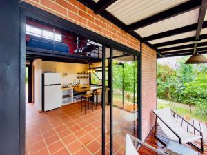 an open kitchen and dining room of a house at Casa Papaya in Los Chacareños