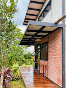 a brick house with a glass roof and a deck at Casa Papaya in Los Chacareños +11 photos