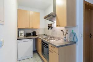 a small kitchen with a stove and a sink at Ferienwohnung Edda in Klütz