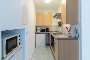 a small kitchen with a sink and a refrigerator at Ferienwohnung Edda in Klütz