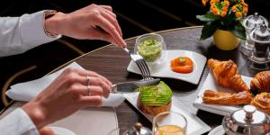 a woman is eating food on a table at The Lantern Central Hotel in Baku