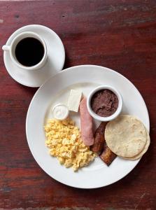 a plate of breakfast foods with a cup of coffee at El Bosque Hotel in Copán Ruinas +36 photos