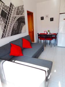 a living room with a couch and a table with red pillows at Dream Apto Old Town in Málaga