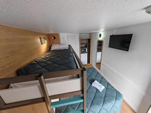 a small room with a bed and a bunk bed at Premiere Classe Nancy Est Essey in Essey-lès-Nancy