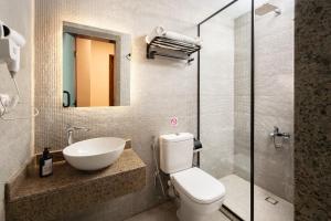 a bathroom with a toilet and a sink and a mirror at Cairo Capital Hotel by SK in Cairo