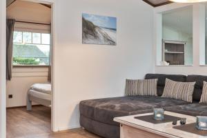 a living room with a couch and a table at Horn sien Hus in Simonsberg +22 photos