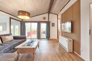 a living room with a couch and a coffee table at Horn sien Hus in Simonsberg