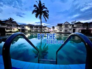 a view of a resort swimming pool with a palm tree at MILANO By The Beach Goa in Benaulim